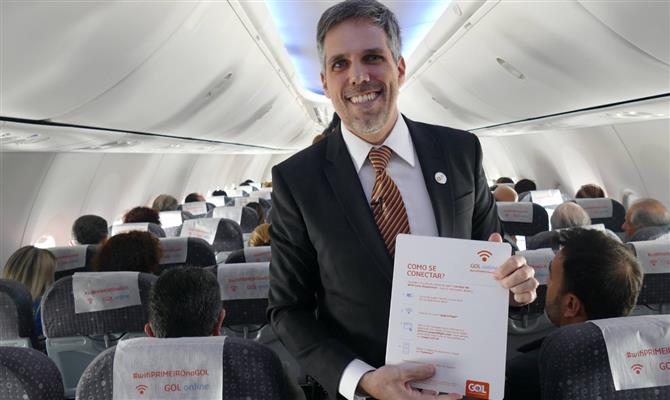 Paulo Kakinoff, presidente da Gol, entrega aos passageiros panfleto com instruções de uso do wi-fi