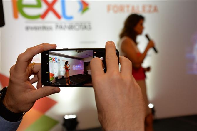 O celular de José Guilherme Alcorta, da PANROTAS, registra a palestra de Maria Camilla Alcorta, da Ideas4Brand