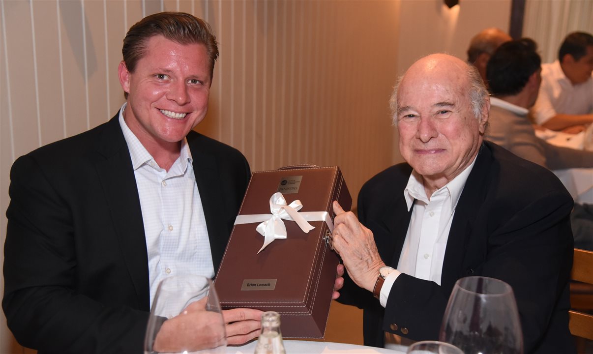 O presidente interino e CEO do Visit St. Pete/Clearwater, Brian Lowack, recebe o presente personalizado de Guillermo Alcorta, da PANROTAS