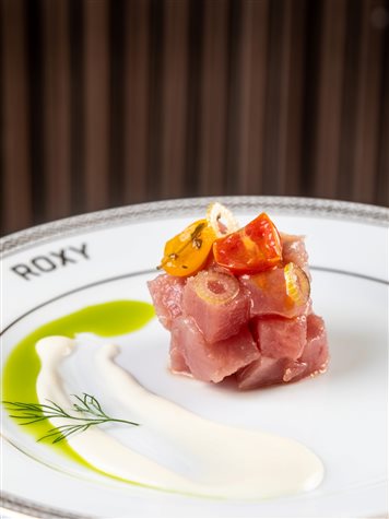 Crudo de atum acompanhado de uma cremosa coalhada de queijo de cabra, picles de erva-doce e mini tomates